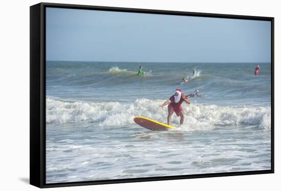 Surfing Santas, Cocoa Beach, Florida, USA-Lisa Engelbrecht-Framed Stretched Canvas