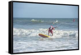 Surfing Santas, Cocoa Beach, Florida, USA-Lisa Engelbrecht-Framed Stretched Canvas