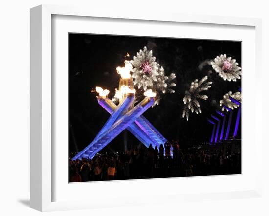 Surrounding the Olympic Flame as Fireworks Explode after the Opening Ceremony of 2010 Winter Games-null-Framed Photographic Print