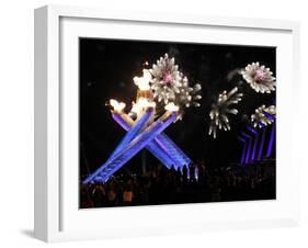 Surrounding the Olympic Flame as Fireworks Explode after the Opening Ceremony of 2010 Winter Games-null-Framed Photographic Print