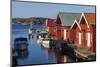 Sweden, Bohuslan, Kungshamn, red fishing shacks in the Fisketangen, old fisherman's neighborhood-Walter Bibikow-Mounted Photographic Print