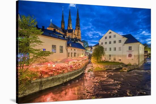 Sweden, Central Sweden, Uppsala, Domkyrka Cathedral with riverfront cafe, dusk-Walter Bibikow-Stretched Canvas