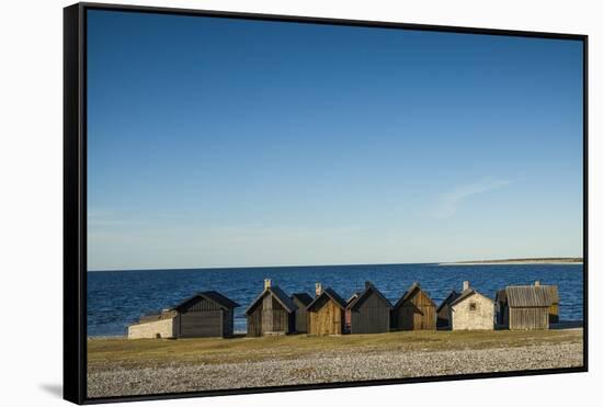 Sweden, Faro Island, Kursviken, coastal farmers fishing shacks, sunset-Walter Bibikow-Framed Stretched Canvas