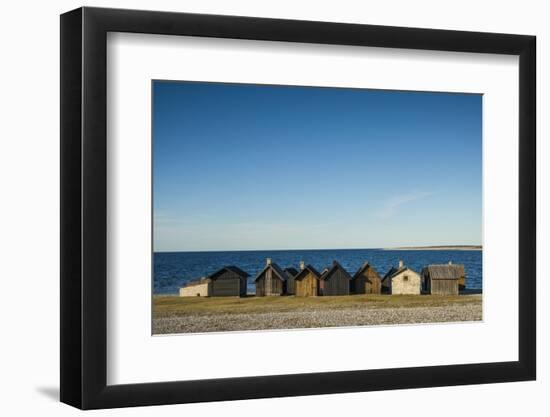 Sweden, Faro Island, Kursviken, coastal farmers fishing shacks, sunset-Walter Bibikow-Framed Photographic Print