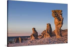 Sweden, Faro Island, Langhammars Area, Langhammar coastal limestone rauk rock, sunset-Walter Bibikow-Stretched Canvas