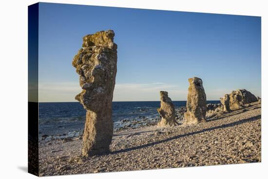 Sweden, Faro Island, Langhammars Area, Langhammar coastal limestone rauk rock, sunset-Walter Bibikow-Stretched Canvas