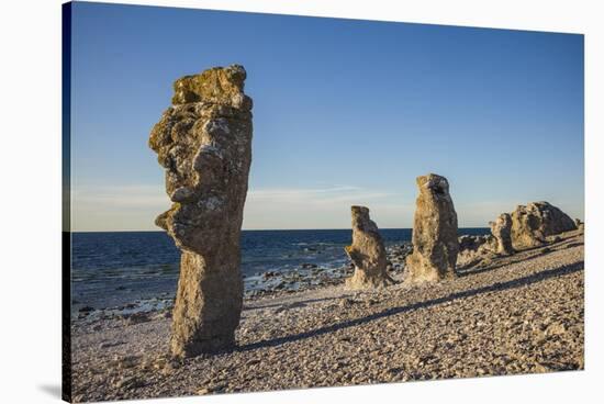 Sweden, Faro Island, Langhammars Area, Langhammar coastal limestone rauk rock, sunset-Walter Bibikow-Stretched Canvas