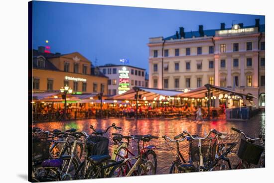 Sweden, Linkoping, cafes and bars on Stora target square, dusk-Walter Bibikow-Stretched Canvas