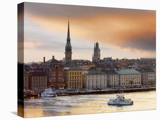 Sweden, Stockholm, Riddarfjarden, Gamla Stan, Passenger Ferries in Bay at Dusk-Shaun Egan-Stretched Canvas