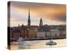 Sweden, Stockholm, Riddarfjarden, Gamla Stan, Passenger Ferries in Bay at Dusk-Shaun Egan-Stretched Canvas