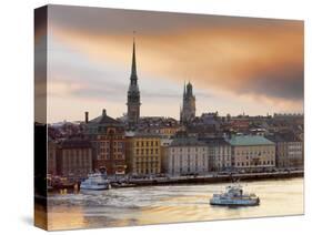 Sweden, Stockholm, Riddarfjarden, Gamla Stan, Passenger Ferries in Bay at Dusk-Shaun Egan-Stretched Canvas