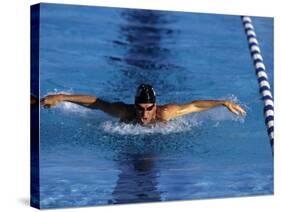 Swimmer Competing in a Butterfly Race-null-Stretched Canvas