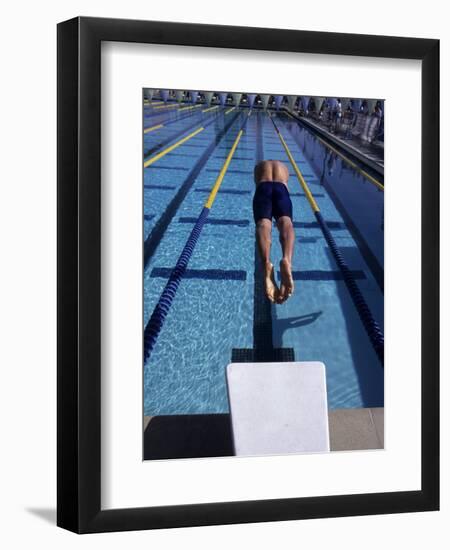 Swimmer Diving Off the Starting Blocks to Begin a Race-Steven Sutton-Framed Premium Photographic Print