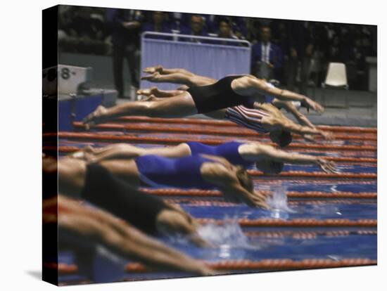 Swimmers Diving to Start a Race at Summer Olympics-null-Stretched Canvas