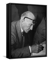 Swiss Architect Le Corbusier Leaning Down to Write with His Glasses Pushed Back on His Forehead-null-Framed Stretched Canvas