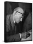 Swiss Architect Le Corbusier Leaning Down to Write with His Glasses Pushed Back on His Forehead-null-Framed Stretched Canvas