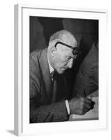 Swiss Architect Le Corbusier Leaning Down to Write with His Glasses Pushed Back on His Forehead-null-Framed Photographic Print