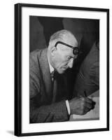 Swiss Architect Le Corbusier Leaning Down to Write with His Glasses Pushed Back on His Forehead-null-Framed Photographic Print