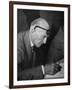 Swiss Architect Le Corbusier Leaning Down to Write with His Glasses Pushed Back on His Forehead-null-Framed Photographic Print