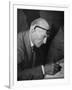 Swiss Architect Le Corbusier Leaning Down to Write with His Glasses Pushed Back on His Forehead-null-Framed Photographic Print