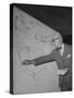 Swiss Architect Le Corbusier Standing on Stage with Notes in His Hand and Drawing on Sketch Pad-null-Stretched Canvas