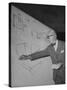 Swiss Architect Le Corbusier Standing on Stage with Notes in His Hand and Drawing on Sketch Pad-null-Stretched Canvas
