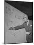Swiss Architect Le Corbusier Standing on Stage with Notes in His Hand and Drawing on Sketch Pad-null-Mounted Premium Photographic Print