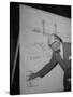 Swiss Architect Le Corbusier Standing on Stage with Notes in His Hand and Drawing on Sketch Pad-null-Stretched Canvas