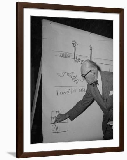 Swiss Architect Le Corbusier Standing on Stage with Notes in His Hand and Drawing on Sketch Pad-null-Framed Photographic Print