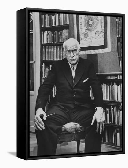 Swiss Psychiatrist Dr. Carl Jung Holding Pipe as He Sits on Chair in His Library at Home-Dmitri Kessel-Framed Stretched Canvas
