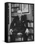 Swiss Psychiatrist Dr. Carl Jung Holding Pipe as He Sits on Chair in His Library at Home-Dmitri Kessel-Framed Stretched Canvas