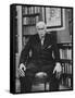 Swiss Psychiatrist Dr. Carl Jung Holding Pipe as He Sits on Chair in His Library at Home-Dmitri Kessel-Framed Stretched Canvas