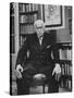 Swiss Psychiatrist Dr. Carl Jung Holding Pipe as He Sits on Chair in His Library at Home-Dmitri Kessel-Stretched Canvas