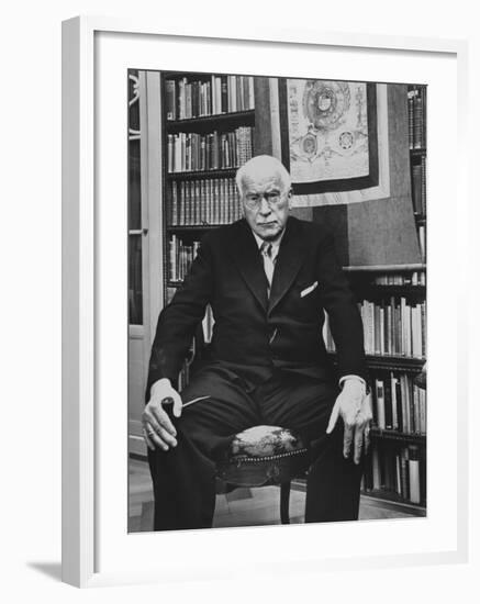 Swiss Psychiatrist Dr. Carl Jung Holding Pipe as He Sits on Chair in His Library at Home-Dmitri Kessel-Framed Premium Photographic Print