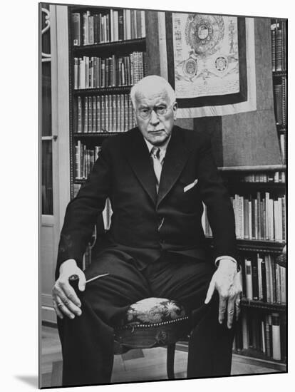 Swiss Psychiatrist Dr. Carl Jung Holding Pipe as He Sits on Chair in His Library at Home-Dmitri Kessel-Mounted Premium Photographic Print