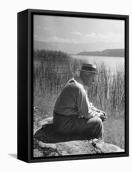 Swiss Psychiatrist Dr. Carl Jung Sitting on Stone Wall Overlooking Lake Zurich-Dmitri Kessel-Framed Stretched Canvas