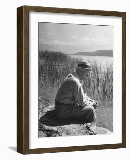 Swiss Psychiatrist Dr. Carl Jung Sitting on Stone Wall Overlooking Lake Zurich-Dmitri Kessel-Framed Premium Photographic Print