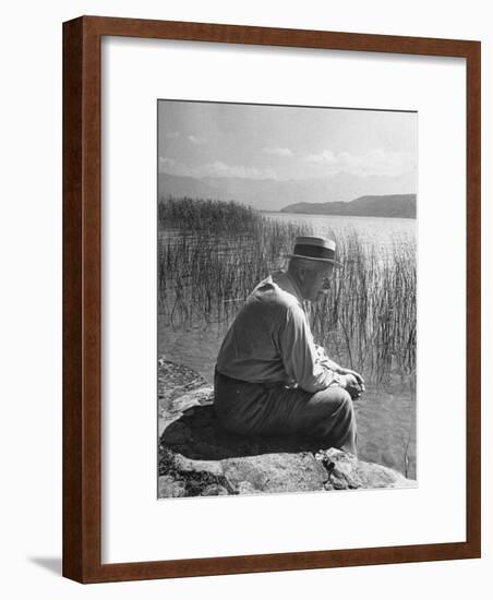 Swiss Psychiatrist Dr. Carl Jung Sitting on Stone Wall Overlooking Lake Zurich-Dmitri Kessel-Framed Premium Photographic Print