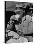 Syndicated Columnist Walter Winchell Clad in Overcoat and Gloves Drinking Coffee in Outdoor Patio-Alfred Eisenstaedt-Stretched Canvas