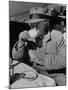 Syndicated Columnist Walter Winchell Clad in Overcoat and Gloves Drinking Coffee in Outdoor Patio-Alfred Eisenstaedt-Mounted Premium Photographic Print