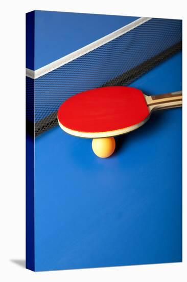 Table Tennis or Ping Pong Rackets and Balls on a Blue Table-Andreyuu-Stretched Canvas