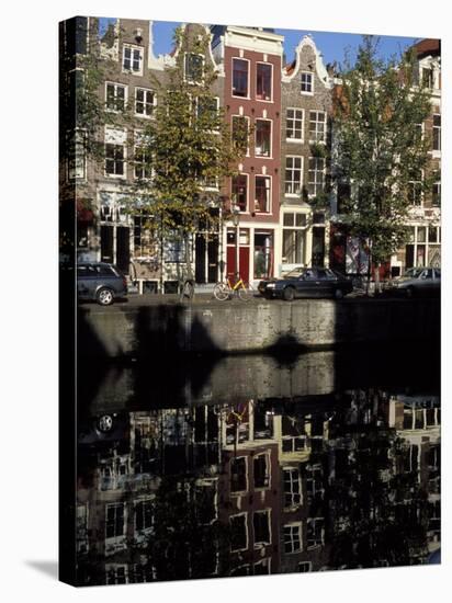 Tall Traditional Style Houses Reflected in the Water of a Canal, Amsterdam, the Netherlands-Richard Nebesky-Stretched Canvas