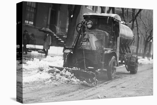 Tank Truck with Snow Plow Cleans the Streets-null-Stretched Canvas