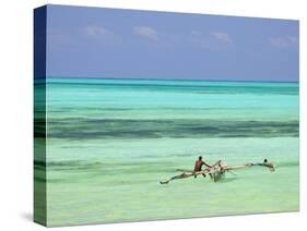 Tanzania, Zanzibar, Unguja, Jambiani, a Man Sits on His Boat Near the Shore-Nick Ledger-Stretched Canvas