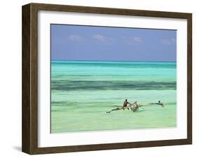 Tanzania, Zanzibar, Unguja, Jambiani, a Man Sits on His Boat Near the Shore-Nick Ledger-Framed Photographic Print