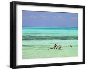 Tanzania, Zanzibar, Unguja, Jambiani, a Man Sits on His Boat Near the Shore-Nick Ledger-Framed Photographic Print