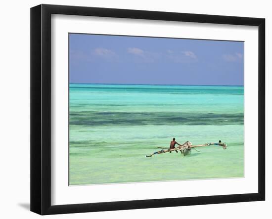 Tanzania, Zanzibar, Unguja, Jambiani, a Man Sits on His Boat Near the Shore-Nick Ledger-Framed Photographic Print