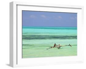 Tanzania, Zanzibar, Unguja, Jambiani, a Man Sits on His Boat Near the Shore-Nick Ledger-Framed Photographic Print