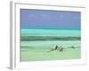 Tanzania, Zanzibar, Unguja, Jambiani, a Man Sits on His Boat Near the Shore-Nick Ledger-Framed Photographic Print