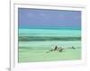 Tanzania, Zanzibar, Unguja, Jambiani, a Man Sits on His Boat Near the Shore-Nick Ledger-Framed Photographic Print